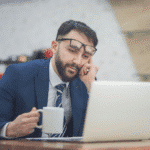 Want To Start A Business? Why Not Consider These 9 Options 2 A man sits with his laptop, thinking about how to start a business.