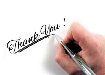 A person hand writing Thank you using Pen focusing on Gratitude to develop positive mindset.