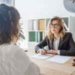 How to Explain Employment Gaps (and When You Don't Need To) 1 Professional reviewing a resume in an office setting, representing How to Explain Employment Gaps